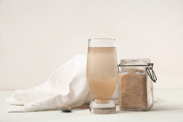 Glass of water with psyllium husk on white background