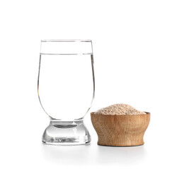 Glass of water with psyllium husk powder on white background