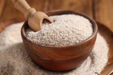 Bowl with psyllium husk powder on table, closeup