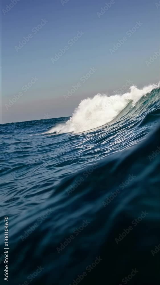 Poster dynamic video capturing a wave crest from a low angle, emphasizing the ocean's power and motion, wit