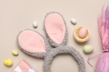 Bunny ears with Easter eggs on beige background