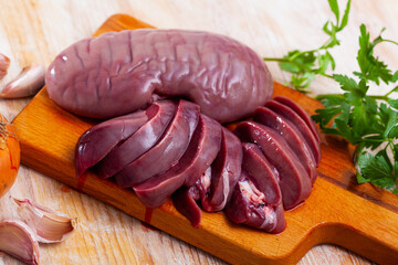 Raw pork kidneys ready for cooking on cutting board