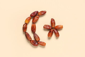 Crescent and star made of tasty dried dates on color background. Ramadan celebration