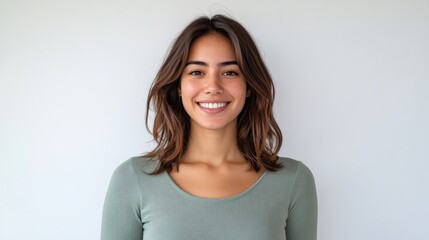 Fototapeta premium Smiling young adult caucasian female with brown hair against white background