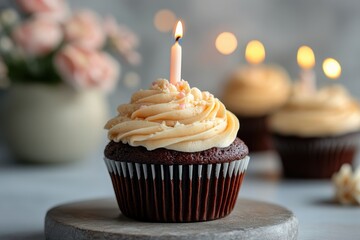 Chocolate cupcake with cream frosting and candle for celebration