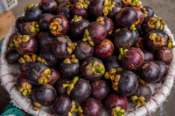 Mangosteen fruit in the basket at the top angle.