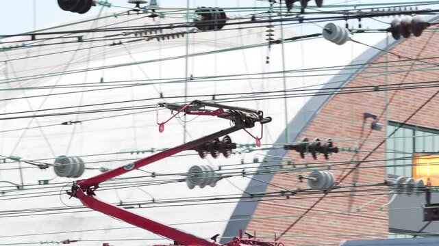 Pantograph for a moving high-speed electric train connected to the catenary wire.