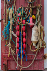 Close up of various types of fishing equipment hanging on a door