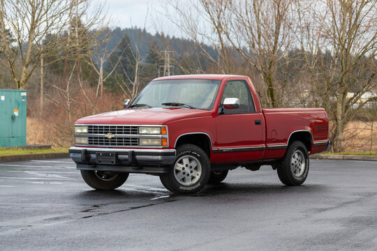 Portland, OR, USA &ndash; Dec 9, 2020 &ndash; 1990 red Chevrolet Silverado 1500 regular cab pickup American 4x4 truck, SUV, off-road vehicle, vintage square-body style with chrome and black trim