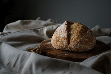 Artisan Batard Sourdough healthy Bread. Open crumb high hydration Sourdough french country bread set on dark background.