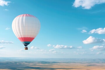 Fototapeta premium serene hot air balloon floats gracefully across clear blue sky with gentle clouds vast open plains stretch below inviting