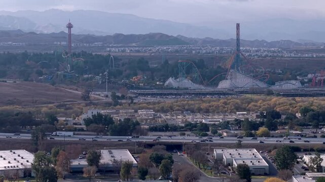 Valencia, California with a view of Magic Mountain beyond Interstate 5 - push in aerial view on a hazy day
