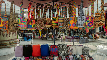 Colorful traditional Andean woven bags displayed at a textile market in Ecuador