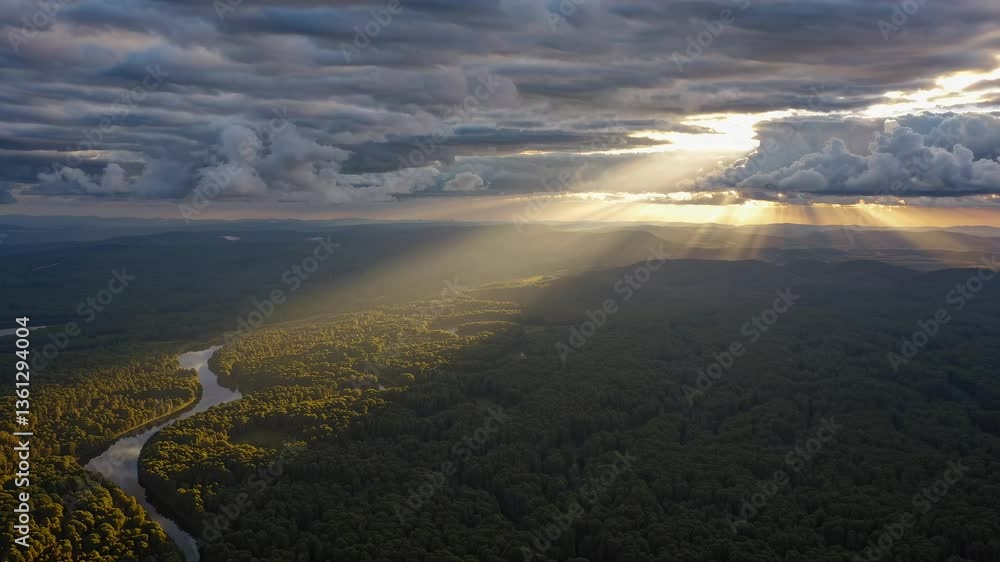 Poster aerial view of a winding river through lush forest under dramatic clouds with sun rays, creating a c