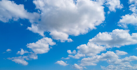 Background with clouds on blue sky. Sky view. Beautiful sunny sky. Clouds on blue sky. Sun shining...