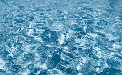 Fototapeta premium Ripple water surface in pool, wave in swimming pool with sun reflection background