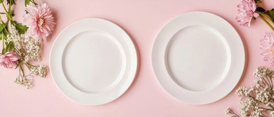 top view of two plates with flower decorations on a table light pink background