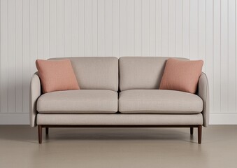 Modern beige sofa with two cushions in stylish interior setting