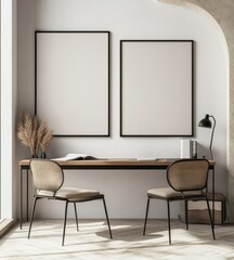 Minimalist home office with two empty frames, wooden desk, and beige chairs.