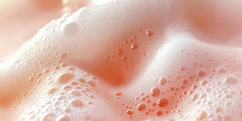 Fototapeta premium Serene composition of foam against a pastel peach-pink background. 