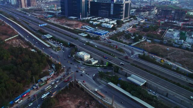 Financial district circle with orr exit No 1 and moving vehicles at Nanakramguda, Financial district, hyderabad, telangana, india. day time, push back, drone shot, 4k.