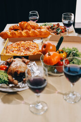 Asian office colleagues and friends enjoy a daytime BBQ with pizza and beer, celebrating Halloween and cheering for their favorite soccer team, creating a lively atmosphere filled with joy.