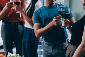 Asian office colleagues and friends enjoy a daytime BBQ with pizza and beer, celebrating Halloween and cheering for their favorite soccer team, creating a lively atmosphere filled with joy.