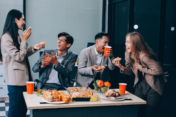 Asian office colleagues and friends enjoy a daytime BBQ with pizza and beer, celebrating Halloween and cheering for their favorite soccer team, creating a lively atmosphere filled with joy.
