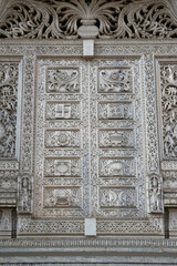 Beautiful carved door, old hindu temple in Mumbai city, Maharashtra, India. Mumbai landmark, monument. Bombay. Indian style, architecture. Heritage. Ornament, decor, decoration with hindu swastika