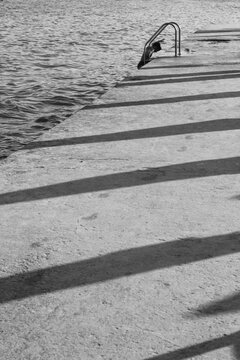 Child Climbing Pier Ladder from Water