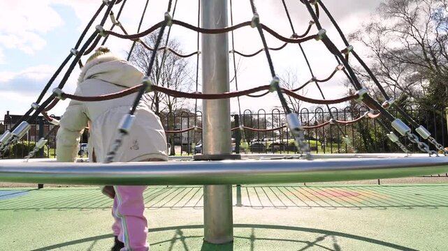 Toddler little girl playing at playground, childhood