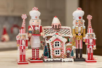 Little nutcrackers standing by gingerbread house