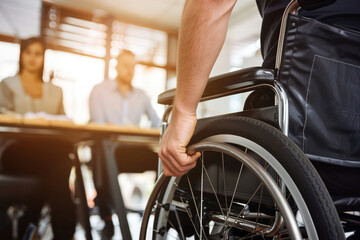Obraz premium Person using a wheelchair presenting ideas, gesturing confidently to colleagues in a modern office