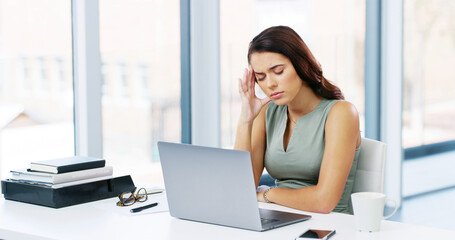 Woman, headache and frustrated with laptop, creative editor and burnout or stress in office. Female copywriter, exhausted and anxiety for project in company, mistake or workplace administration