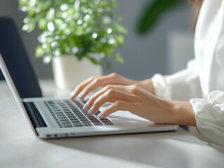 A close-up of hands typing on a keyboard