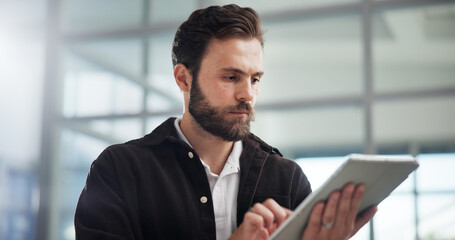 Scroll, creative and business man with tablet in office for networking or social media marketer online. Technology, startup and serious worker reading email, campaign and brand promotion on platform