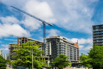 Construction of a new high-rise buildings in residential district . Residential  with multi-apartment high-rise buildings \f1\lang1049\'f8\'f2 Richmond City on a background of blue cloudy  sky