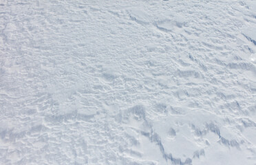 A snow covered ground with a few small snowflakes