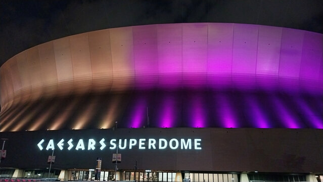 Caesars Superdome New Orleans exterior illuminated prior to Super Bowl LIX