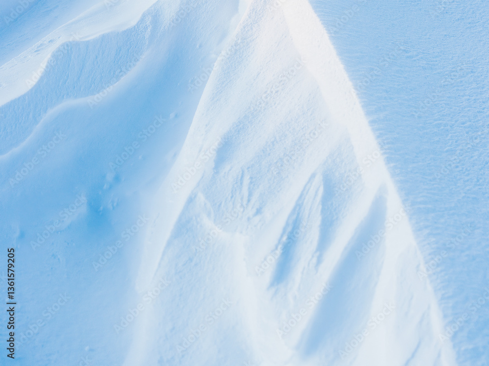 Wall mural snow texture. wind sculpted patterns on snow surface. wind in the tundra and in the mountains on the