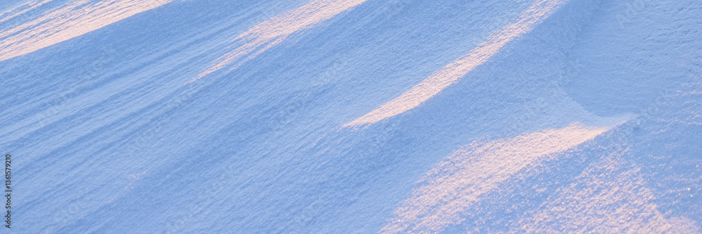 Wall mural snow texture. wind sculpted patterns on snow surface. wind in the tundra and in the mountains on the