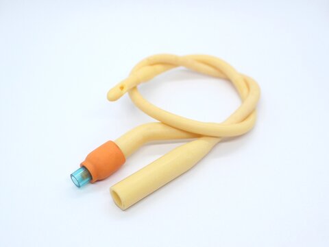 Yellow latex coated silicone catheter foley. Urinary catheter. Urinary tube with 2 lumen isolated on white background