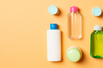 Cosmetics SPA branding mock-up, top view with copy space. set of tubes and jars of cream flat lay on colored background