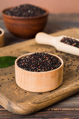 quinoa seeds in bowl and spoon on colored background. Healthy kinwa in small bowl. Healthy superfood