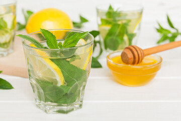 Mojito cocktail. Refreshing mojito cocktail with lime, lemon and mint in a tall glass with a stick