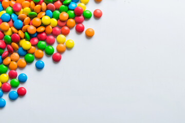 Mixed collection of colorful candy, on colored background. Flat lay, top view. frame of colorful chocolate coated candy