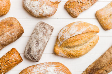Homemade natural breads. Different kinds of fresh bread as background, top view with copy space