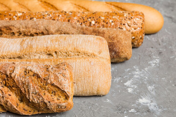 Homemade natural breads. Different kinds of fresh bread as background, perspective view with copy space