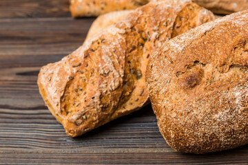 Homemade natural breads. Different kinds of fresh bread as background, perspective view with copy space