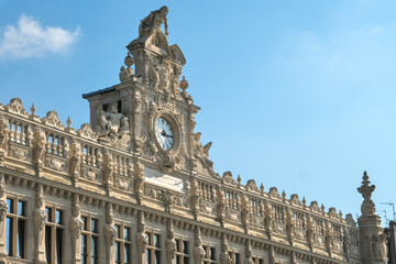 Ornate building facade showcasing intricate sculptural details, decorative elements, and large...
